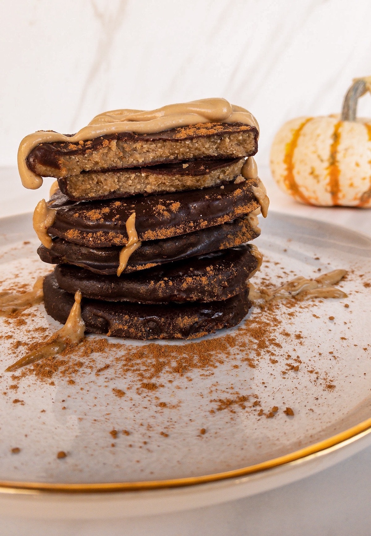 Side view of stack of chocolate pumpkins with sunbutter drizzle