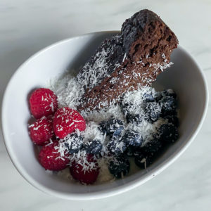 Chocolate banana brea slice in a bowl with yogurt and fruit