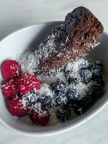 Chocolate banana brea slice in a bowl with yogurt and fruit