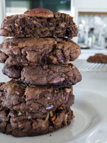 Stack of brown cookies on white plate