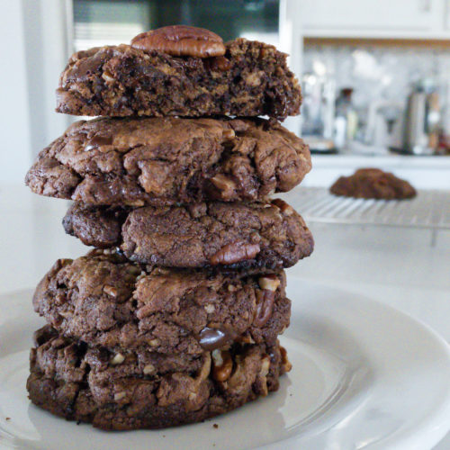 Stack of brown cookies on white plate