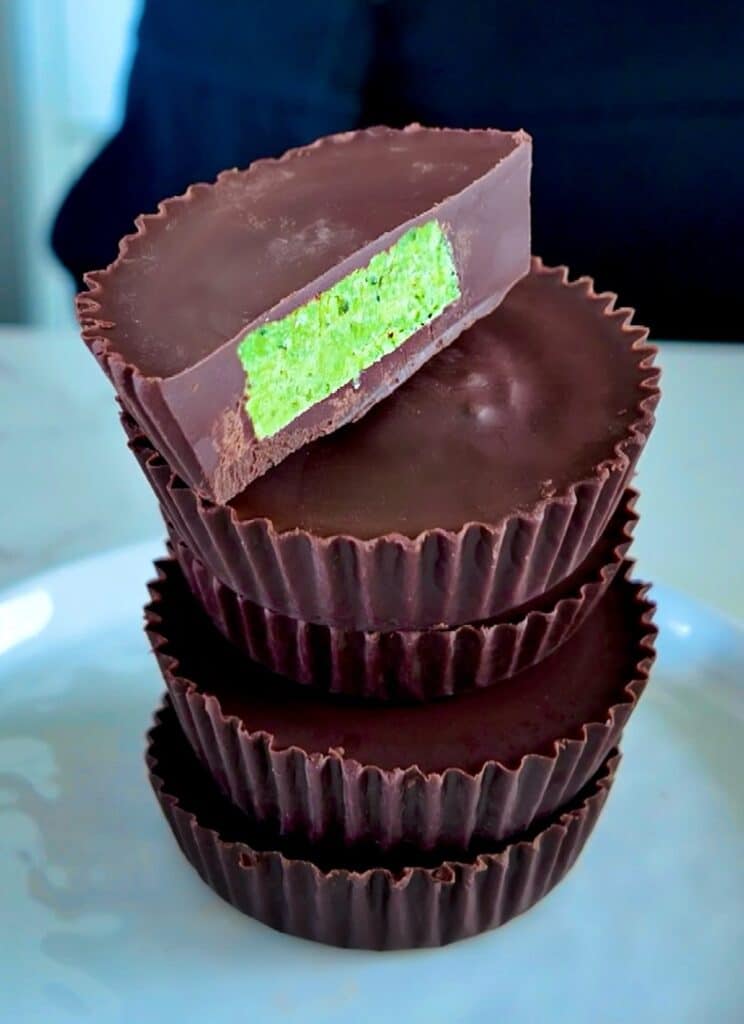 Easy & healthy Chocolate Matcha Mint Cups for dessert stacked in a pile.