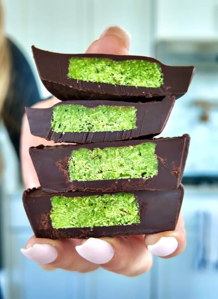 Holding stack of Chocolate Matcha Mint Cups.